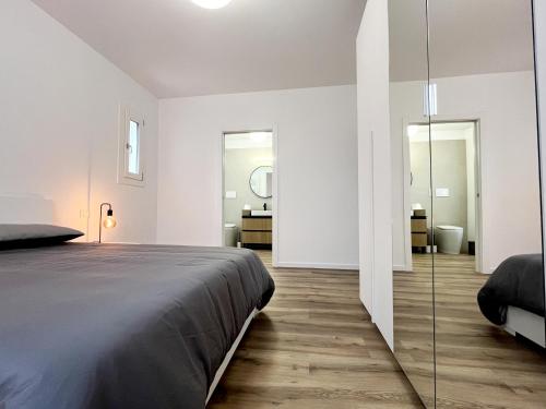 a bedroom with a large bed and a bathroom at Casa Umberto in Marghera