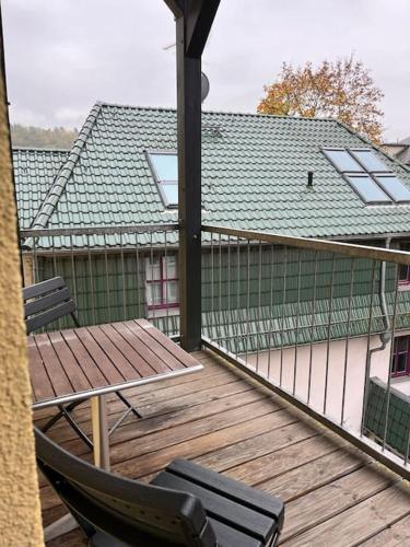 a deck with two chairs and a table on a house at Apartment mit Balkon & Parkplatz in Meißen