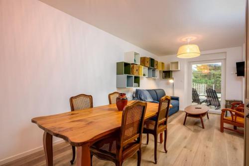 une salle à manger avec une table et des chaises en bois dans l'établissement Les Iris Blancs, à Orbey