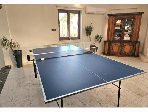 a ping pong table in the middle of a room at Larnaca Mansion Ideal for 3 Families or more in Larnaka
