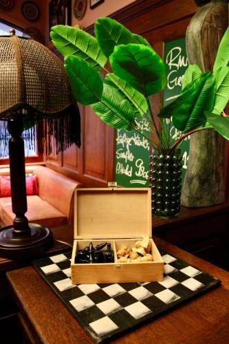 a wooden box on top of a chessboard on a table at Hotel Alma Am Anger in Erfurt