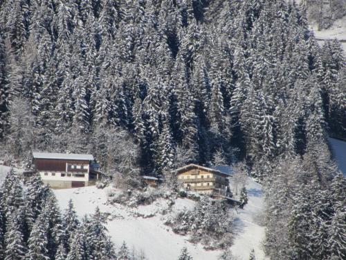 an aerial view of a ski lodge with snow covered trees at Neurauthof in Zellberg