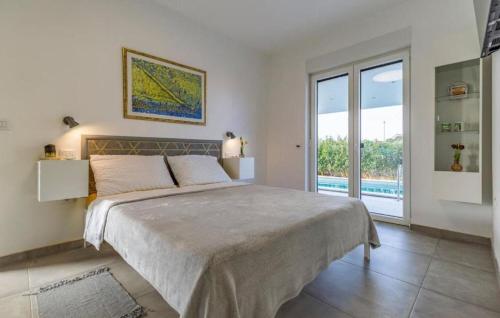 a bedroom with a large bed and a pool at House Dusa in Banjole