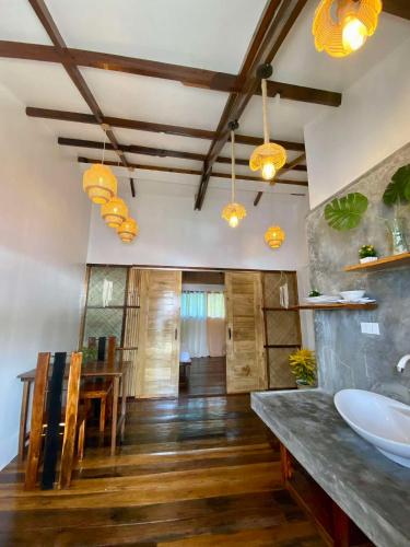 a bathroom with a sink and a dining room at PRECIOUS HOMESTAY - Cozy Room in Burgos