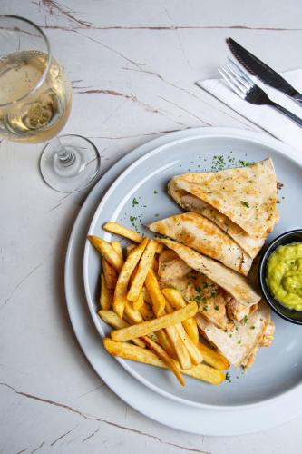 a plate of food with a sandwich and french fries at Hotel Grand Park in Bogotá