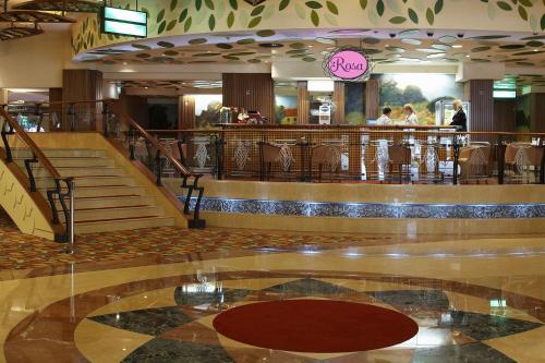 a lobby of a shopping mall with stairs and a restaurant at Park, Hotel & Entertainment in Nova Gorica