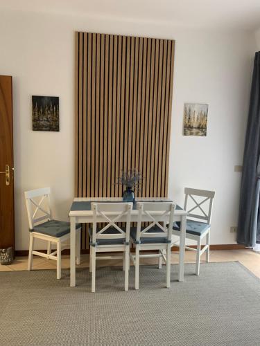 a dining room with a table and two chairs at Centro Tarvisio in Tarvisio