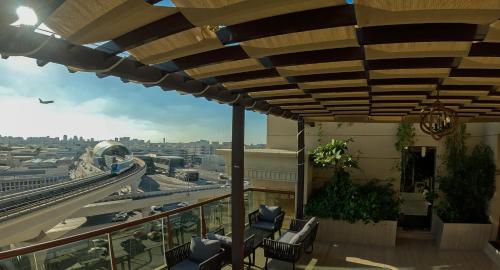 a balcony with chairs and a view of a city at La Zona Continental Hotel in Dubai