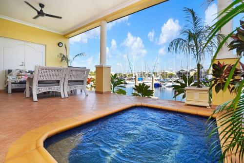 a swimming pool in a patio with a view of a marina at Villa Utopia on the Marina 3 Bed, 3 Bath in Stuart Park