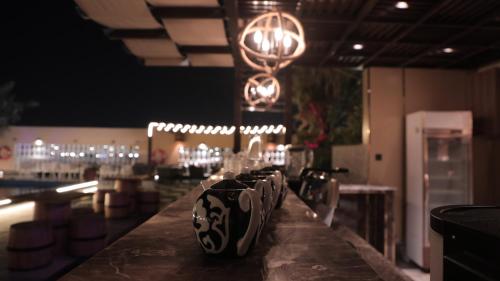 a bar with a bunch of glasses on a counter at La Zona Continental Hotel in Dubai