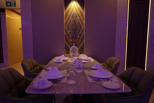 a table in a room with a purple at La Zona Continental Hotel in Dubai