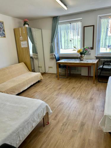 a room with two beds and a table in it at China-Ferienzimmer in Berchtesgaden