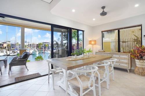 a dining room with a table and chairs at Villa Utopia on the Marina 3 Bed, 3 Bath in Stuart Park