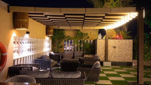 a patio with chairs and tables in a restaurant at La Zona Continental Hotel in Dubai
