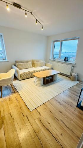 a living room with a couch and a table at Penthouse Atmosphäre mit Meerblick FeWo am Deich 11 in Bremerhaven