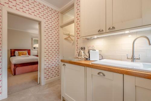 a kitchen with a sink and a bed in a room at The Windmill Room - 1 min to Old Course in St. Andrews