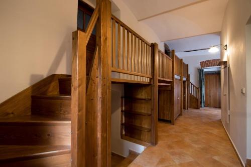 a hallway with wooden stairs in a house at Chaloupka U Černého čápa in Horní Lhota