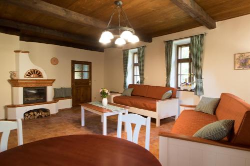 a living room with a couch and a fireplace at Chaloupka U Černého čápa in Horní Lhota