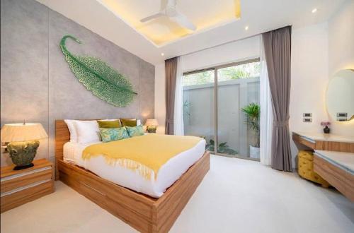 a bedroom with a bed and a large window at Villa private swimming pool and garden in Phuket Town