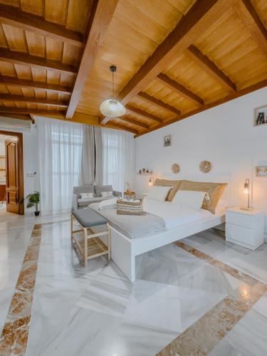 a large bedroom with a bed and a couch at El Mirador De La Consentida Rooms & Suites Boutique in Marbella