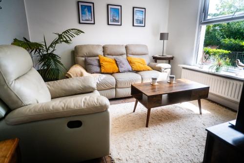 a living room with a couch and a coffee table at Coastal Terrace Retreat- Allocated Parking, 2 Bedrooms in Portsmouth