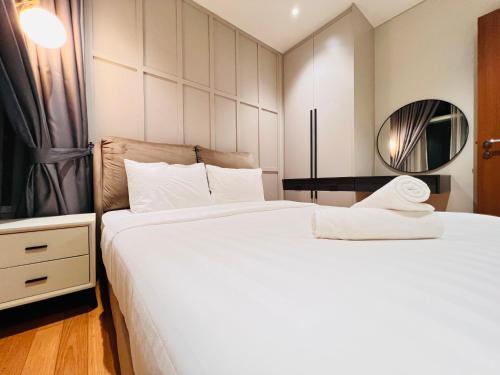 a hotel room with two beds and a mirror at Sky Suites at KLCC by Mitstay in Kuala Lumpur