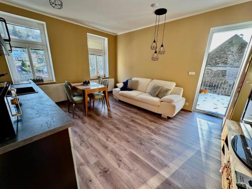 a living room with a couch and a table at Apartmány za Královskou mincovnou in Jáchymov