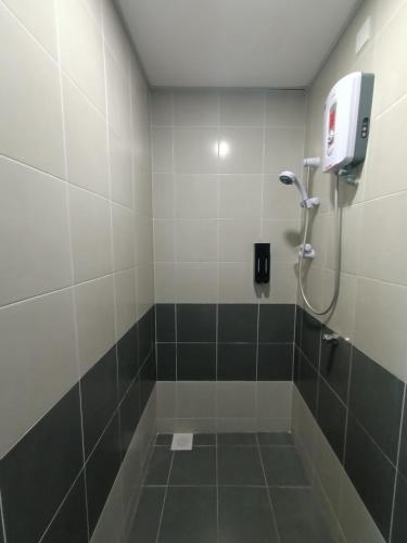 a bathroom with a shower with a bath tub at Dream studio Emerald avenue in Cameron Highlands