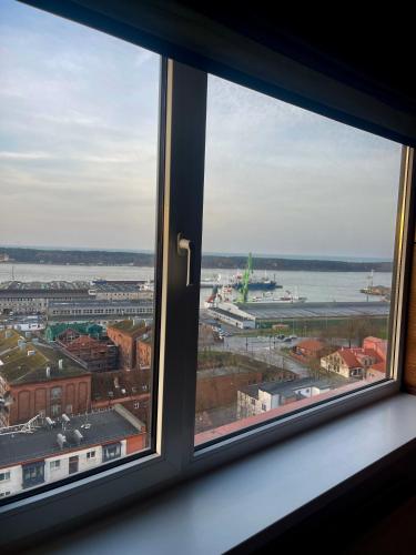a view of a city from a window at Panoramic city center apartment in Klaipėda
