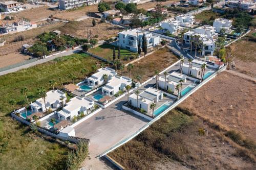 an aerial view of houses and a road with houses at Salty Sun Luxury Villas in Kremasti