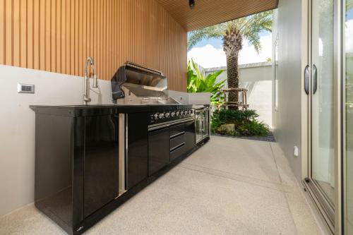 a kitchen with a sink and a stove at Wilawan villas in Phuket Town