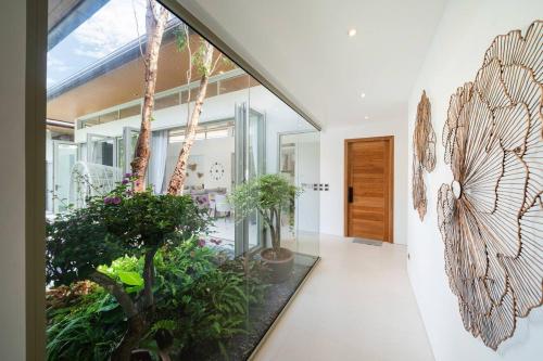 a hallway with potted plants in a house at Wilawan villas in Phuket Town