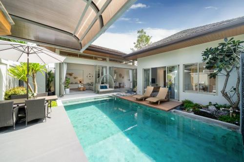 an indoor swimming pool in a house at Wilawan villas in Phuket Town