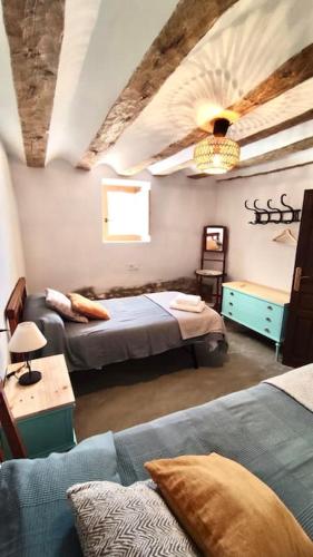 a living room with two beds and a couch at Casas de Vela in Vélez Blanco
