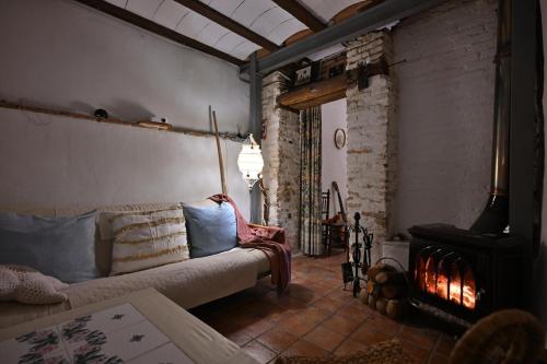 a living room with a couch and a fireplace at 'La Casa de LoLa' casita de cuento con vistas in Arenas de San Pedro