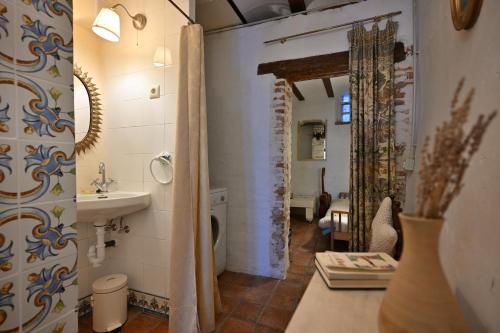 a bathroom with a sink and a toilet at 'La Casa de LoLa' casita de cuento con vistas in Arenas de San Pedro