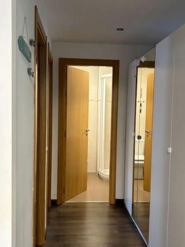 a hallway with two doors and a mirror at El Relax, La Puebla De Castro in La Puebla de Castro