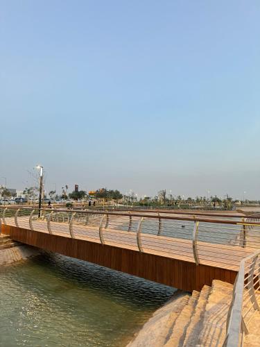 a wooden bridge over a body of water at Small details2 Self-check-in in Riyadh