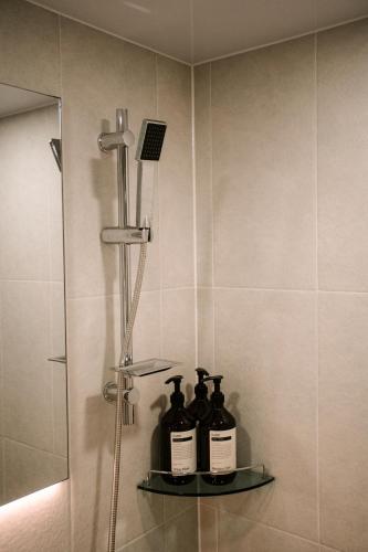 a bathroom with three bottles of wine on a shelf at Gyeongju Record Stay Near tourist attractions in Gyeongju
