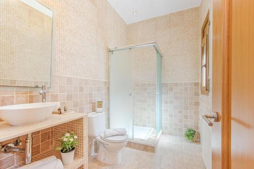 a bathroom with a sink and a toilet and a shower at V024 - Villa Colina in Palau-Saverdera