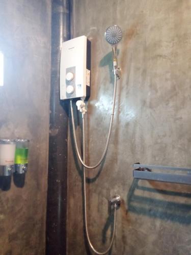a shower in a bathroom with a hair dryer at Hubkhao Resort in Ko Lanta
