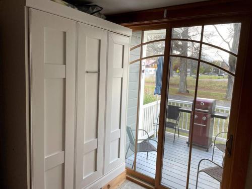 an open door to a porch with a chair on a deck at The Tipsy Gypsy in Hunter