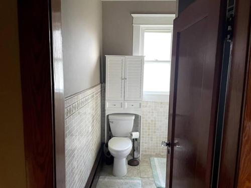 a small bathroom with a toilet and a window at The Tipsy Gypsy in Hunter