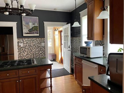 a kitchen with a stove and a microwave at The Tipsy Gypsy in Hunter