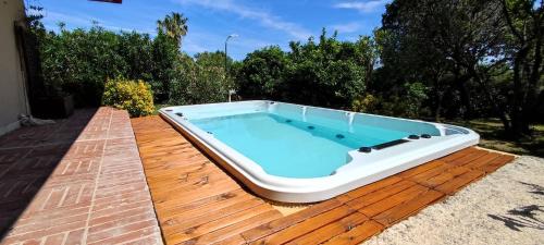 a hot tub sitting on top of a wooden deck at Villa Quadrifoglio in Arenzano
