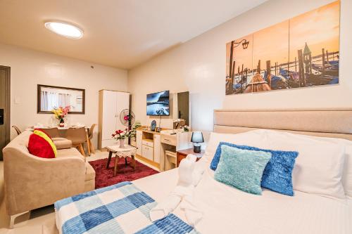 a bedroom with a bed and a living room at Precious Florannjoe in Manila