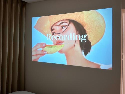 a sign on a wall with a woman eating a lime at Gurida Bupyeong in Incheon