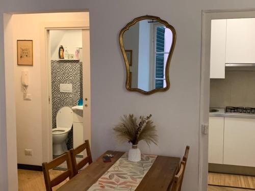 a dining room with a table and a mirror at Cernaia by Farris & Cors in Genova