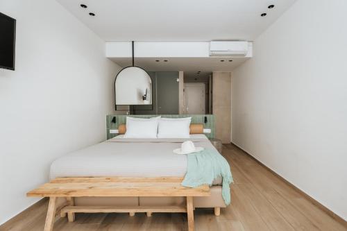 a bedroom with a bed and a table at Paralos The Maxine Adults Only in Agia Galini