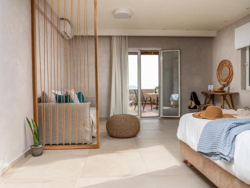 a bedroom with a bed and a view of the ocean at Paralos The Maxine Adults Only in Agia Galini